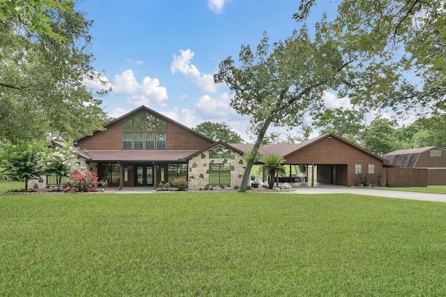 28540 Lynnwood Ln, Hempstead, TX 77445 - back of property with french doors, a yard, concrete driveway, and stone siding