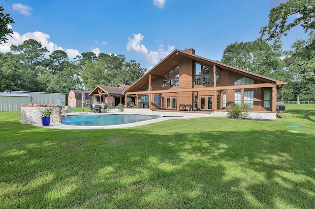 28540 Lynnwood Ln, Hempstead, TX 77445 - back of house with french doors, a chimney, a lawn, an outdoor pool, and a storage unit
