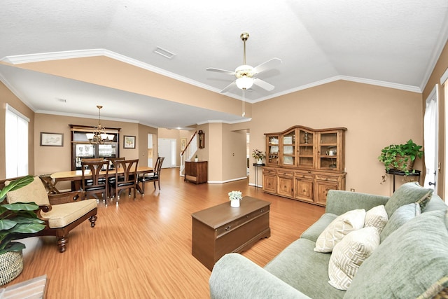 20527 Apache Lake Dr, Katy, TX 77449 - living room featuring lofted ceiling, stairs, light wood-type flooring, healthy amount of natural light, and a chandelier