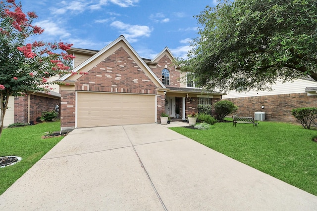 20527 Apache Lake Dr, Katy, TX 77449 - traditional-style home with driveway, a front yard, brick siding, and an attached garage