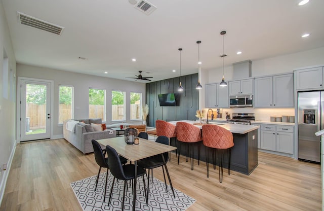 4612 Oats St, Houston, TX 77020 - dining area with light wood finished floors, ceiling fan, and recessed lighting