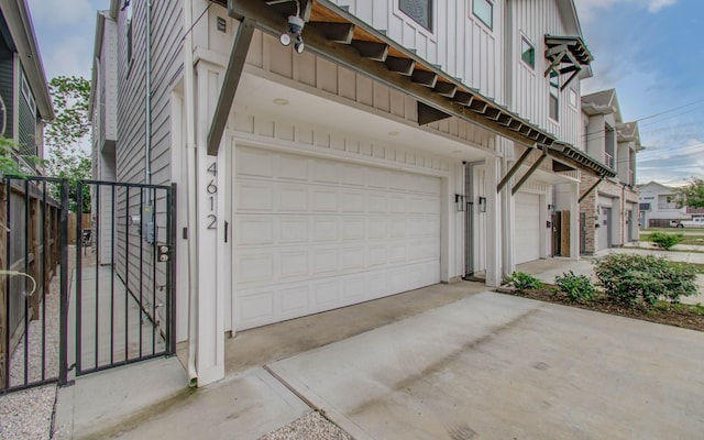 4612 Oats St, Houston, TX 77020 - view of side of home with board and batten siding, a garage, and driveway