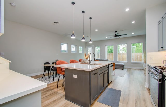 4612 Oats St, Houston, TX 77020 - kitchen featuring stainless steel appliances, open floor plan, light wood-type flooring, recessed lighting, and light countertops