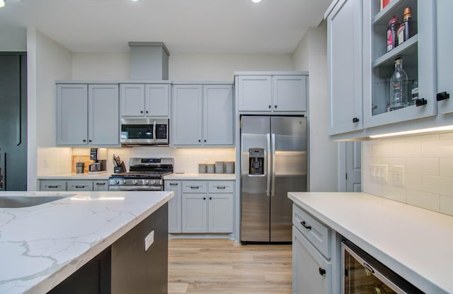 4612 Oats St, Houston, TX 77020 - kitchen featuring stainless steel appliances, tasteful backsplash, light wood-style floors, and recessed lighting