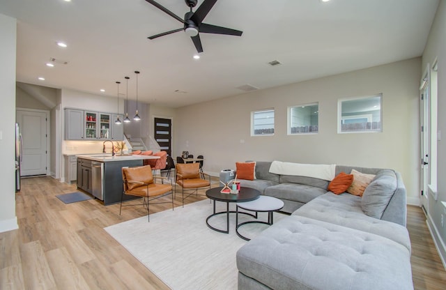 4612 Oats St, Houston, TX 77020 - living room with stairs, light wood-type flooring, recessed lighting, and ceiling fan
