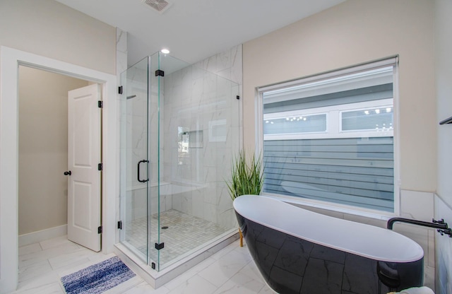 4612 Oats St, Houston, TX 77020 - bathroom with marble finish floors, a stall shower, and a soaking tub