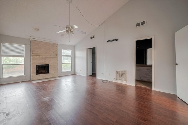 11280 Braes Forest Dr Unit 105, Houston, TX 77071 - unfurnished living room featuring a ceiling fan, high vaulted ceiling, wood finished floors, and a fireplace
