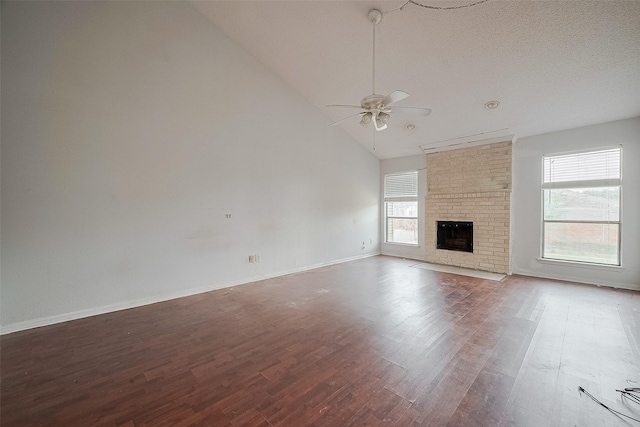 11280 Braes Forest Dr Unit 105, Houston, TX 77071 - unfurnished living room with a ceiling fan, wood finished floors, a fireplace, and high vaulted ceiling