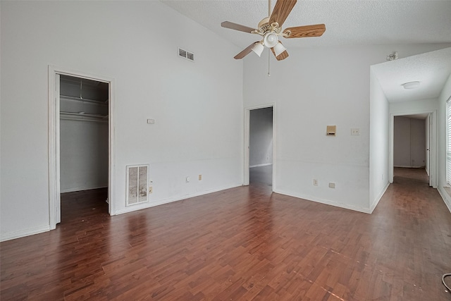11280 Braes Forest Dr Unit 105, Houston, TX 77071 - unfurnished living room featuring high vaulted ceiling, ceiling fan, dark wood-style flooring, and a textured ceiling