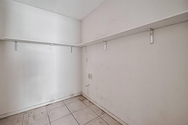 11280 Braes Forest Dr Unit 105, Houston, TX 77071 - walk in closet with light tile patterned floors