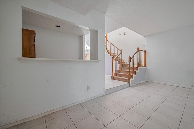 11280 Braes Forest Dr Unit 105, Houston, TX 77071 - tiled empty room with stairway and a textured ceiling