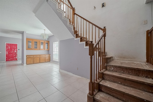 11280 Braes Forest Dr Unit 105, Houston, TX 77071 - stairway featuring tile patterned floors and a chandelier