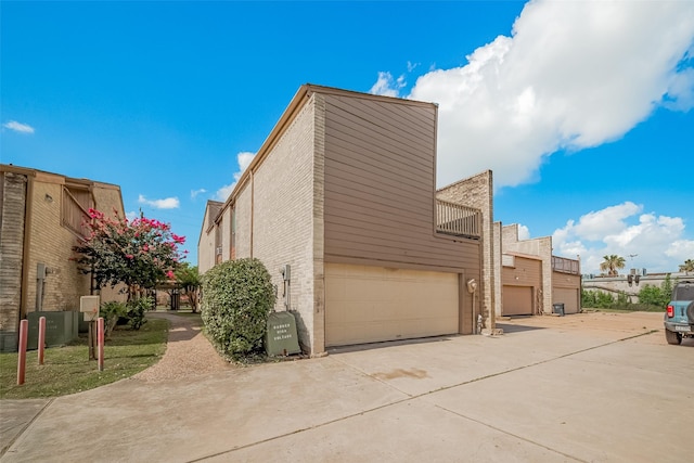 11280 Braes Forest Dr Unit 105, Houston, TX 77071 - view of side of home featuring concrete driveway and a garage
