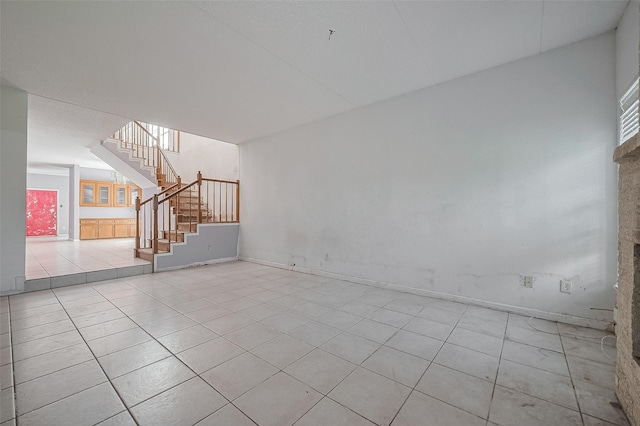 11280 Braes Forest Dr Unit 105, Houston, TX 77071 - unfurnished living room with stairs and tile patterned floors