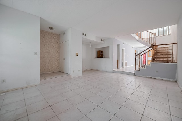 11280 Braes Forest Dr Unit 105, Houston, TX 77071 - unfurnished living room with stairway and light tile patterned floors