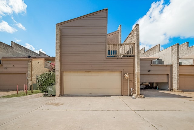 11280 Braes Forest Dr Unit 105, Houston, TX 77071 - back of house with driveway and a garage