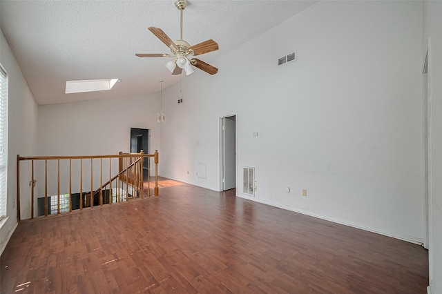 11280 Braes Forest Dr Unit 105, Houston, TX 77071 - spare room with a skylight, ceiling fan, wood finished floors, a textured ceiling, and high vaulted ceiling