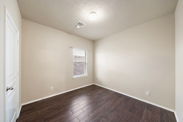 6707 Enchanted Crest Dr, Katy, TX 77449 - unfurnished bedroom with dark wood-style flooring and a textured ceiling