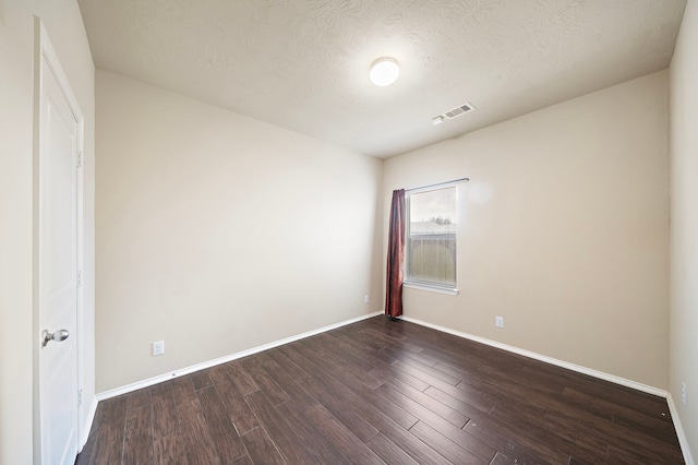 6707 Enchanted Crest Dr, Katy, TX 77449 - unfurnished bedroom with dark wood-style floors and a textured ceiling