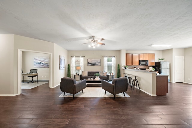 6707 Enchanted Crest Dr, Katy, TX 77449 - living room with dark wood-type flooring, a ceiling fan, and a textured ceiling