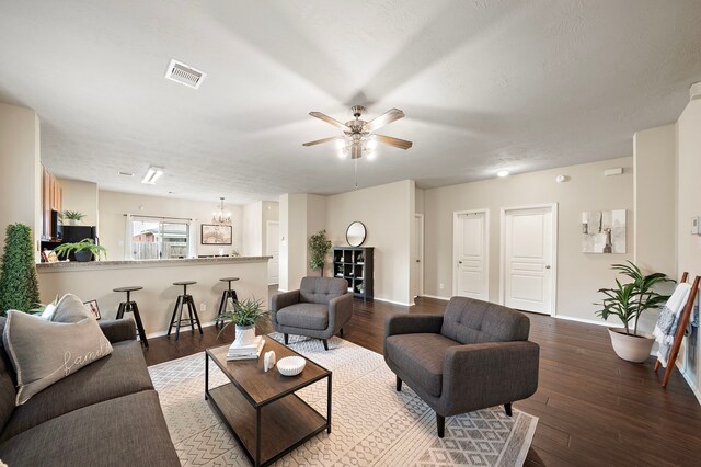 6707 Enchanted Crest Dr, Katy, TX 77449 - living room featuring wood finished floors, ceiling fan, and a chandelier