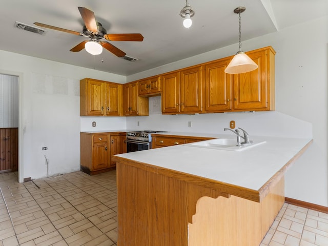 4432 County Road 886, Brazoria, TX 77422 - kitchen with stainless steel stove, a peninsula, brown cabinets, ceiling fan, and light countertops