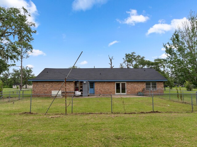 4432 County Road 886, Brazoria, TX 77422 - back of house with a fenced backyard and brick siding