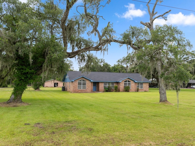 4432 County Road 886, Brazoria, TX 77422 - ranch-style home featuring a front yard and brick siding