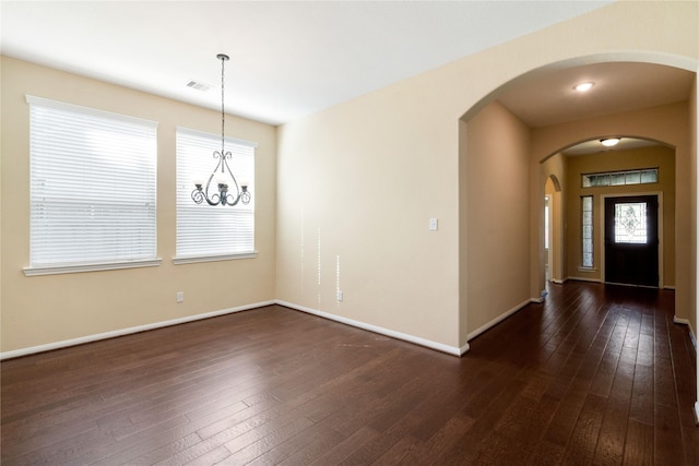 38 Tallgrass Way, Spring, TX 77389 - foyer featuring dark wood-style floors, arched walkways, healthy amount of natural light, and a chandelier