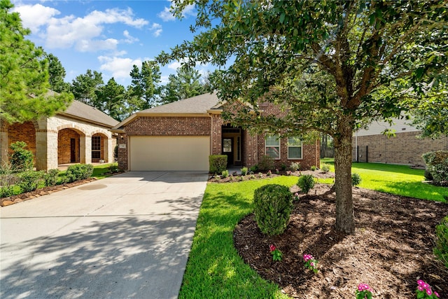38 Tallgrass Way, Spring, TX 77389 - view of front of property featuring a garage, driveway, a front lawn, and brick siding