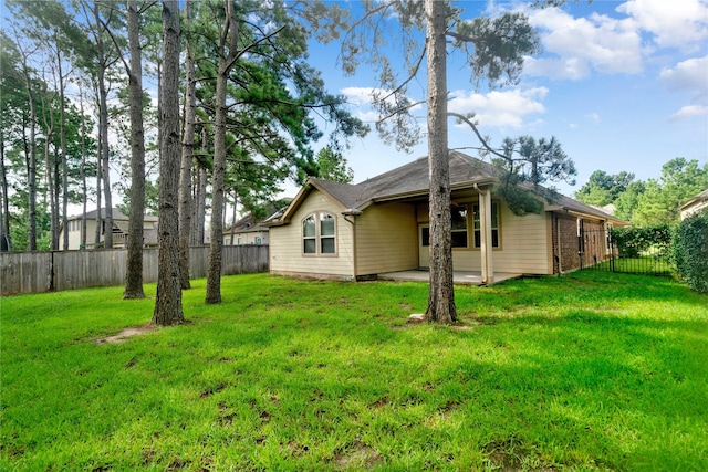38 Tallgrass Way, Spring, TX 77389 - rear view of property featuring a fenced backyard, a patio area, and a carport