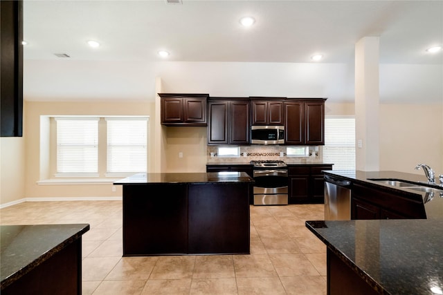 38 Tallgrass Way, Spring, TX 77389 - kitchen featuring stainless steel appliances, a center island, healthy amount of natural light, light tile patterned flooring, and recessed lighting