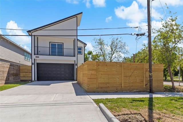 4102 Kewanee St, Houston, TX 77051 - contemporary home featuring a balcony, an attached garage, stucco siding, and concrete driveway