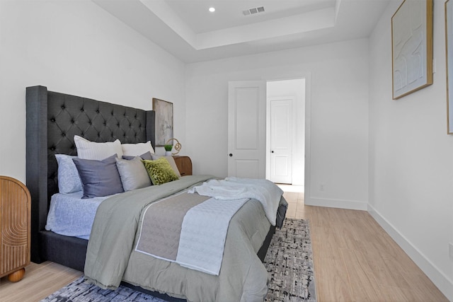 825 Rd 5501, Cleveland, TX 77327 - bedroom featuring light wood-style floors and a tray ceiling