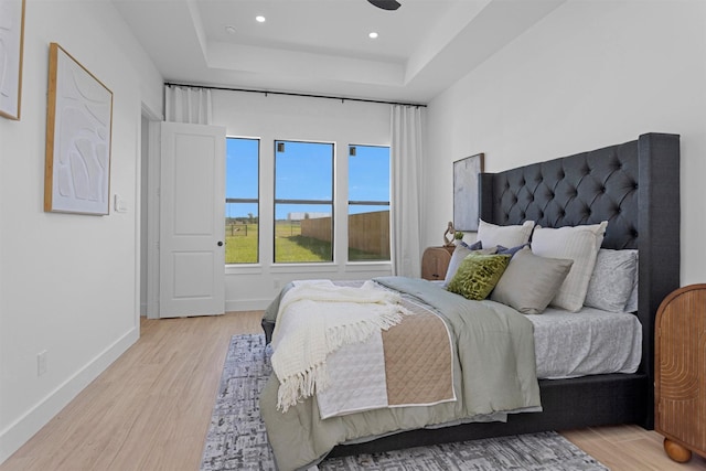 825 Rd 5501, Cleveland, TX 77327 - bedroom featuring light wood-type flooring, a tray ceiling, and recessed lighting