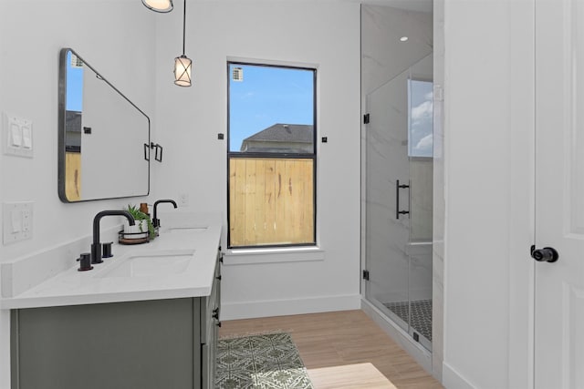 825 Rd 5501, Cleveland, TX 77327 - full bathroom featuring double vanity, a marble finish shower, and wood finished floors