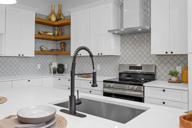 825 Rd 5501, Cleveland, TX 77327 - kitchen featuring stainless steel range with electric stovetop, wall chimney exhaust hood, open shelves, and white cabinets