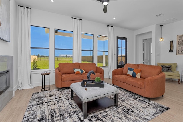 825 Rd 5501, Cleveland, TX 77327 - living room with healthy amount of natural light, light wood-style flooring, ceiling fan, and recessed lighting