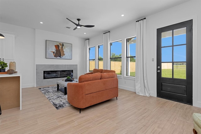 825 Rd 5501, Cleveland, TX 77327 - living room with a fireplace, ceiling fan, light wood-type flooring, and recessed lighting