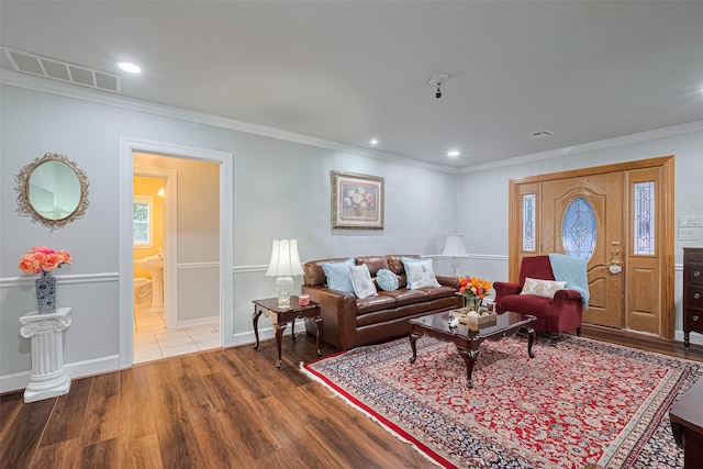 7833 Narcissus St, Houston, TX 77012 - living room with crown molding, wood finished floors, and recessed lighting
