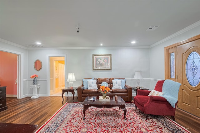 7833 Narcissus St, Houston, TX 77012 - living room featuring wood finished floors, crown molding, and recessed lighting