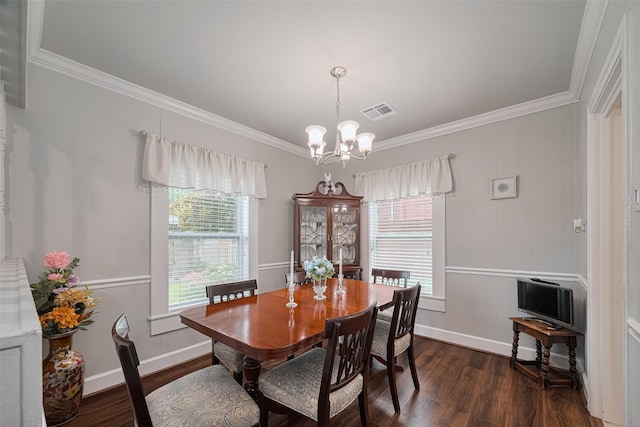 7833 Narcissus St, Houston, TX 77012 - dining area with ornamental molding, a chandelier, and dark wood-type flooring