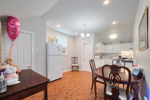 7833 Narcissus St, Houston, TX 77012 - kitchen with white appliances, lofted ceiling, a chandelier, white cabinetry, and recessed lighting