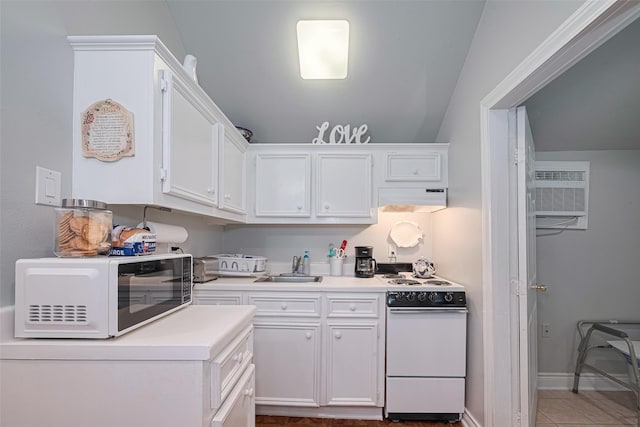 7833 Narcissus St, Houston, TX 77012 - kitchen featuring white appliances, under cabinet range hood, white cabinets, light countertops, and a wall mounted AC