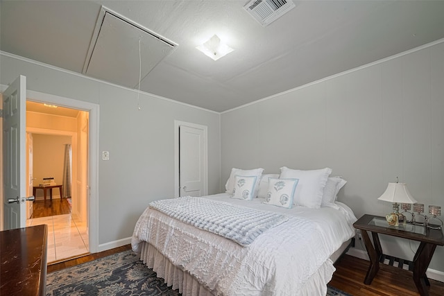 7833 Narcissus St, Houston, TX 77012 - bedroom featuring attic access, wood finished floors, and crown molding