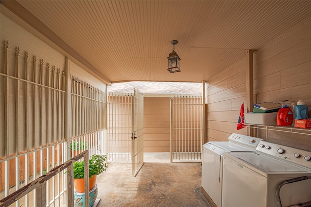 7833 Narcissus St, Houston, TX 77012 - laundry area with washing machine and clothes dryer and wooden walls
