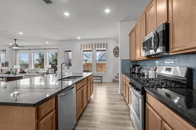 10502 William Park Dr, Missouri City, TX 77459 - kitchen featuring stainless steel appliances, recessed lighting, ceiling fan, light wood-type flooring, and backsplash