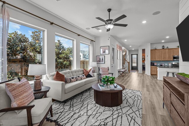 10502 William Park Dr, Missouri City, TX 77459 - living area with light wood finished floors, recessed lighting, a ceiling fan, and stairway