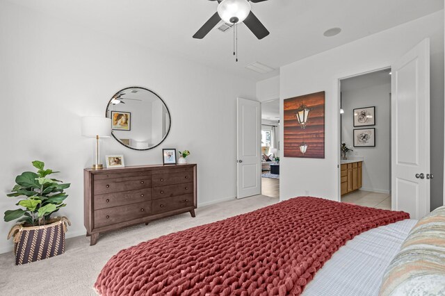 10502 William Park Dr, Missouri City, TX 77459 - bedroom with light carpet, ensuite bathroom, and ceiling fan