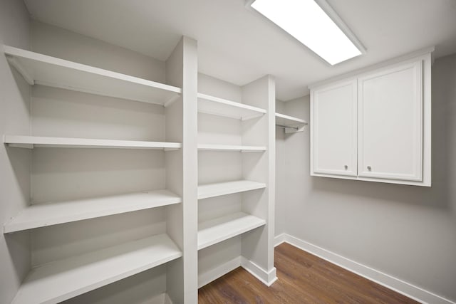 5135 Loch Lomond Dr, Houston, TX 77096 - walk in closet with dark wood-style flooring